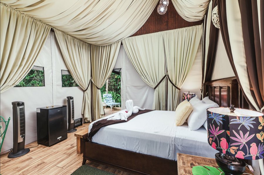 Listing photo of the bed with lamps and folded towels