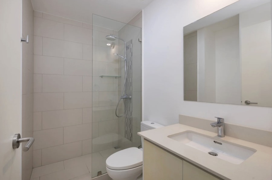 Listing photo of a bathroom with a glass shower and vanity